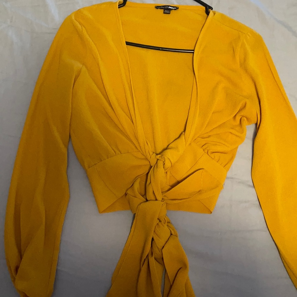 long sleeve cropped shirt. The color is mustard